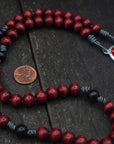 St. Michael centerpiece detail on rosary with silver hardware and red-black wooden beads