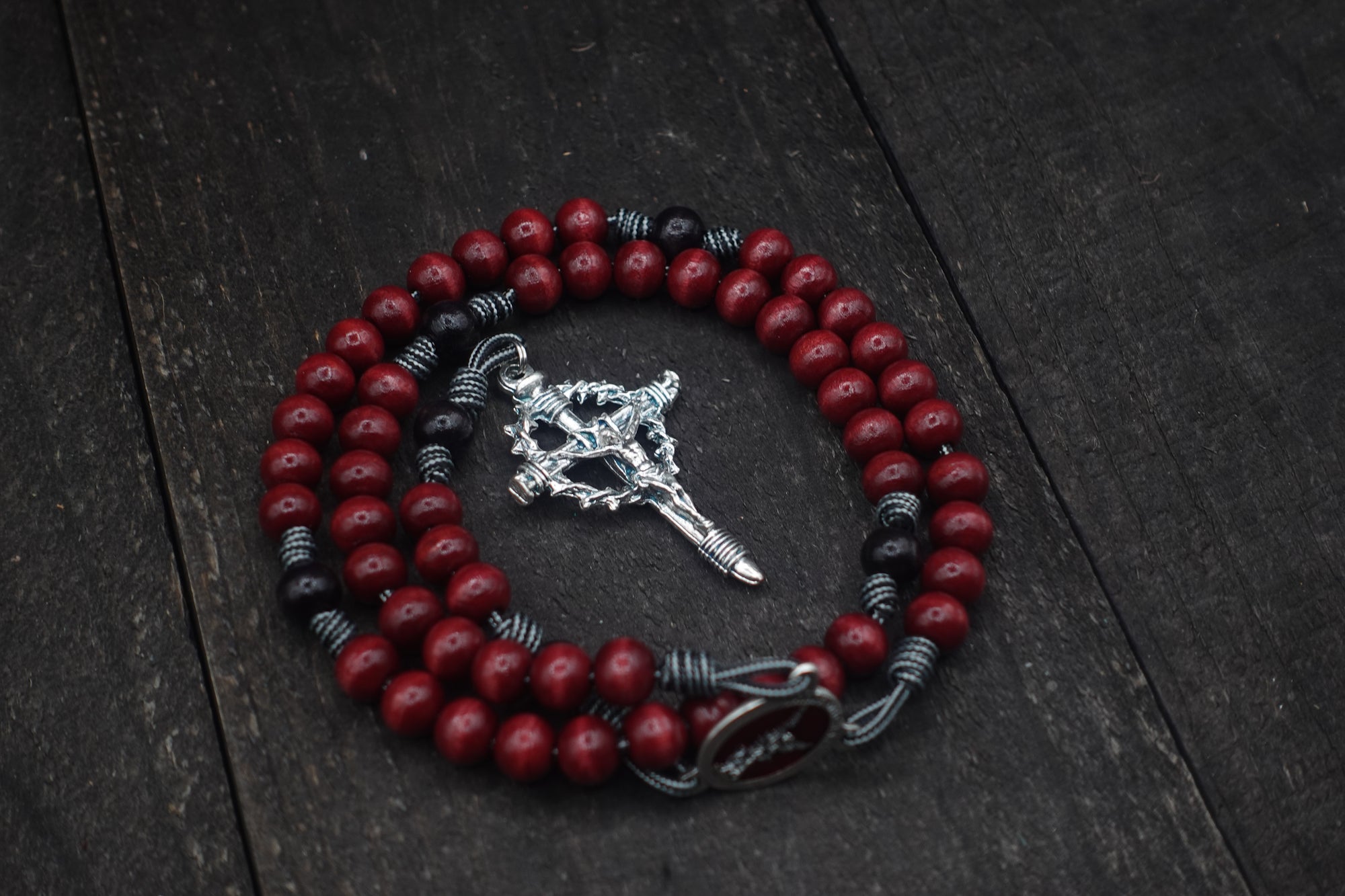 Rugged handmade St. Michael rosary crafted in Fargo ND with silver crucifix and red wooden beads