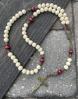 Handmade Christmas rosary featuring red and white wood beads with bronze crucifix and medal centerpiece