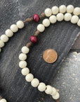 Close-up of red and vintage white wooden beads on St. Nicholas Christmas rosary showing heirloom craftsmanship