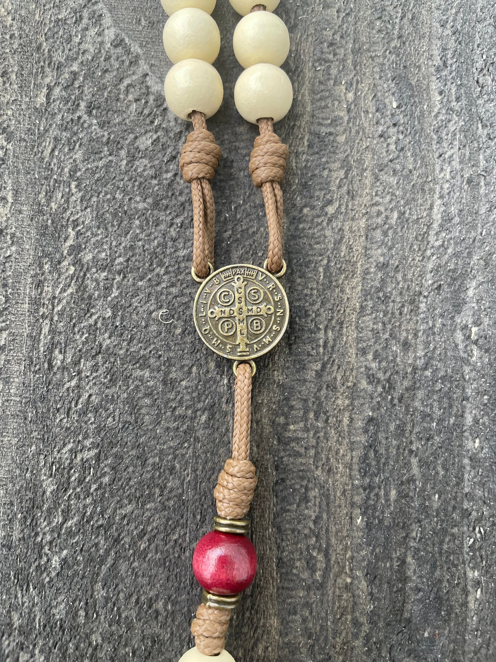 Bronze St. Benedict medal centerpiece on St. Nicholas Christmas rosary with red and white beads
