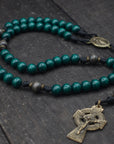 Durable black paracord rosary built for daily prayer with bronze Celtic hardware and green wooden beads