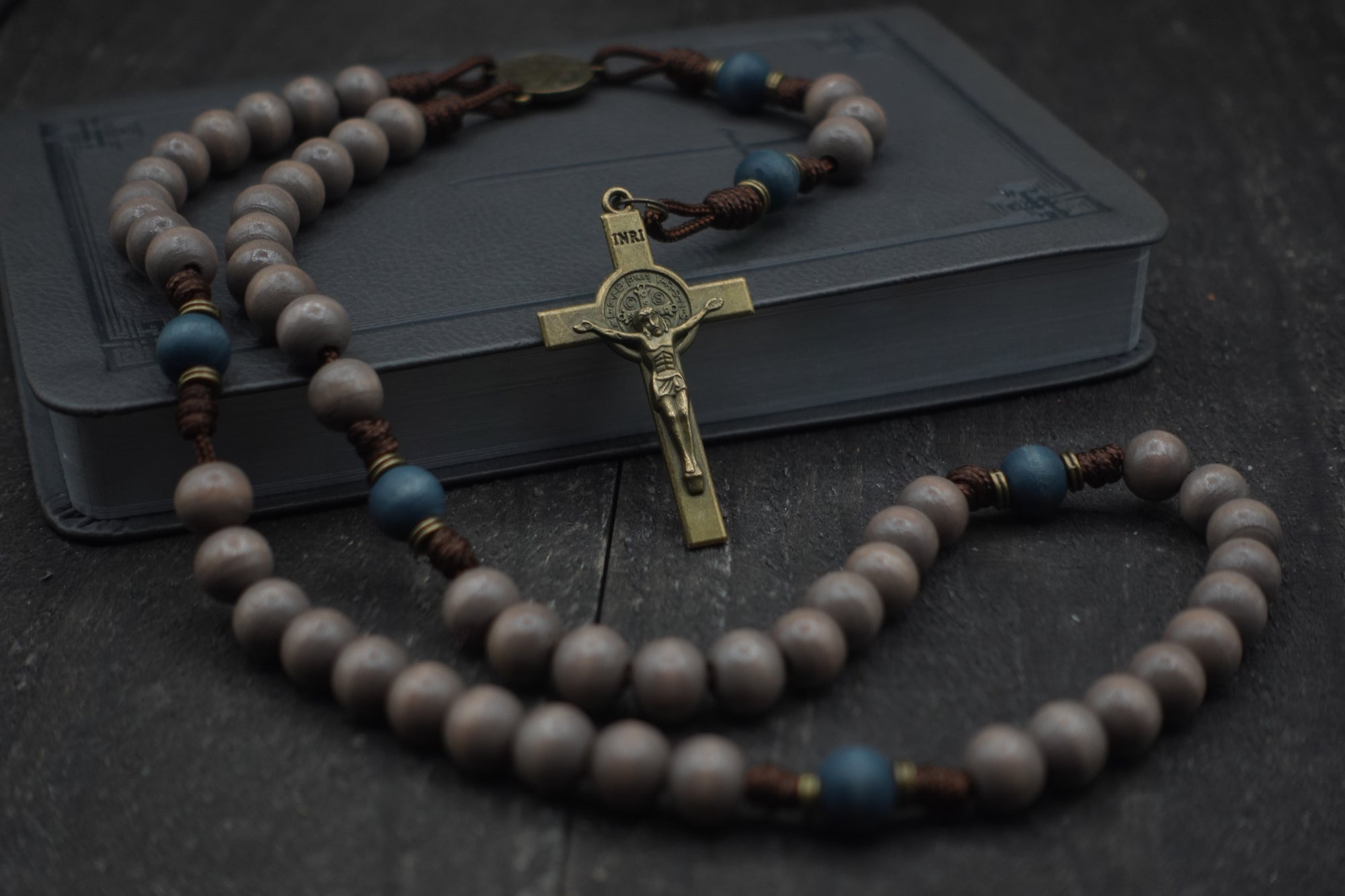 Durable paracord rosary built for daily prayer with bronze hardware and hand-stained wooden beads