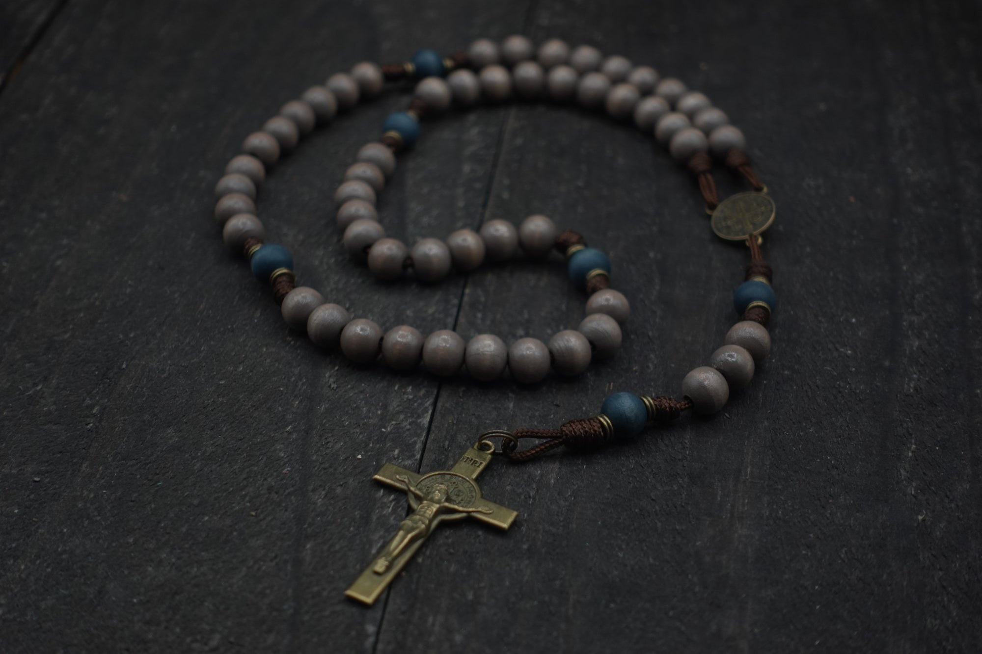 Ave Maris Stella rosary with light gray and navy wooden beads, bronze St. Benedict crucifix, and walnut paracord