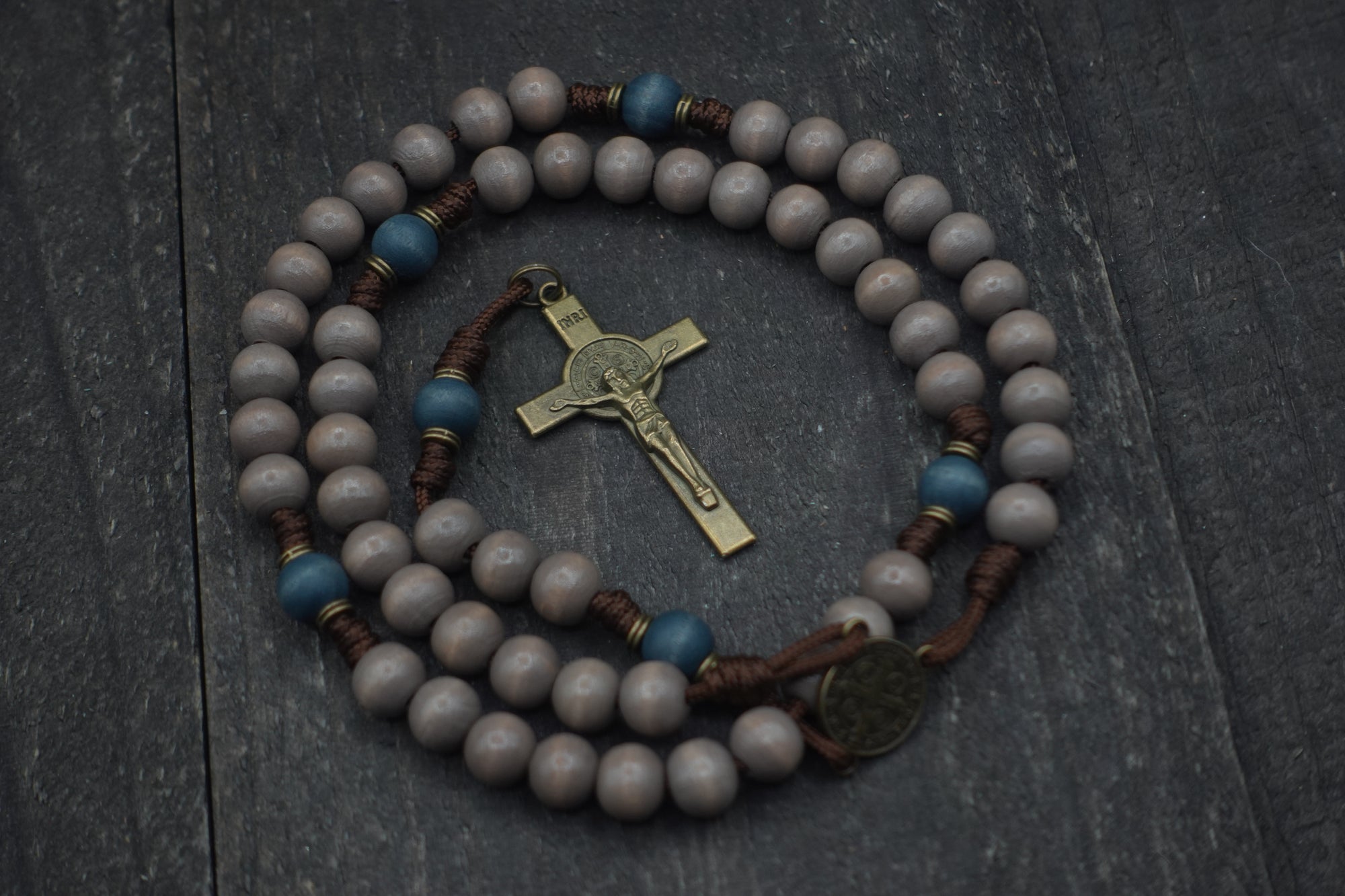 Handcrafted Ave Maris Stella rosary for daily prayer featuring bronze crucifix and gray-blue wooden beads