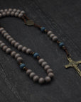 Ave Maris Stella rosary by Runewood Rosary combining gray and navy wood beads, bronze crucifix, and walnut paracord for faithful devotion
