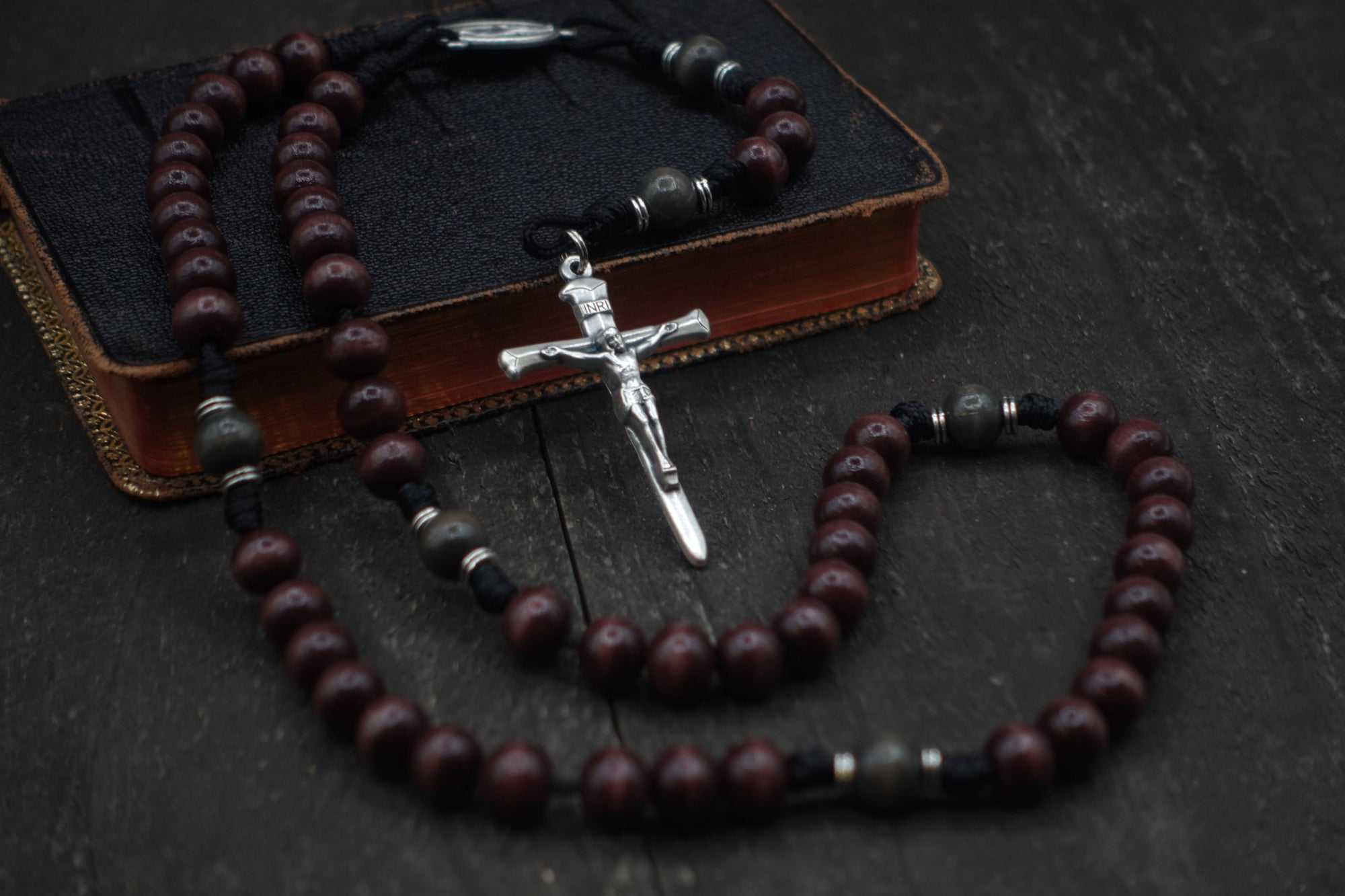 Terror of Demons rosary with purple and charcoal wooden beads, silver Nails crucifix, and durable black paracord