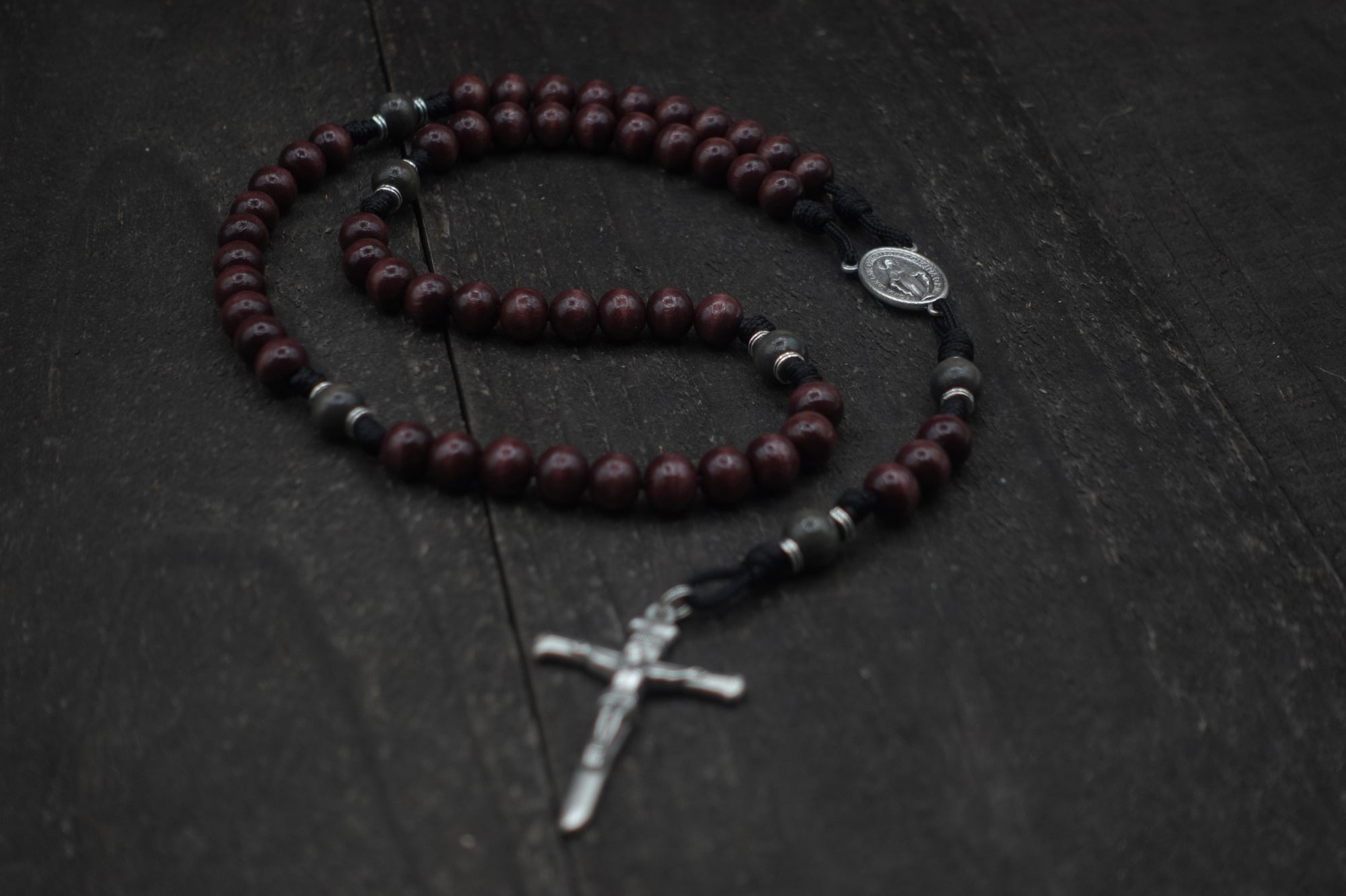 Rugged handmade Terror of Demons rosary crafted in Fargo ND with silver crucifix and dark wooden beads