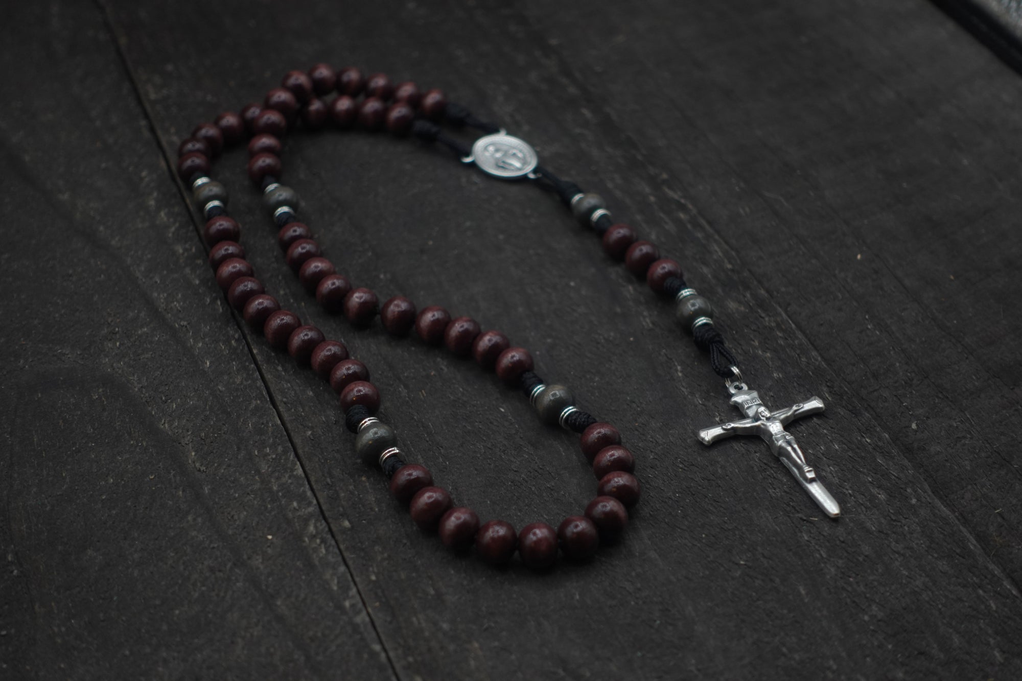 Handcrafted Terror of Demons rosary for daily prayer featuring silver crucifix and dark wooden beads