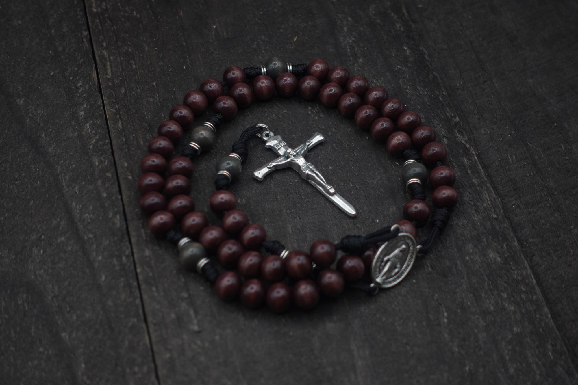 Terror of Demons rosary by Runewood Rosary combining dark wood beads, silver crucifix, and black paracord for faithful devotion