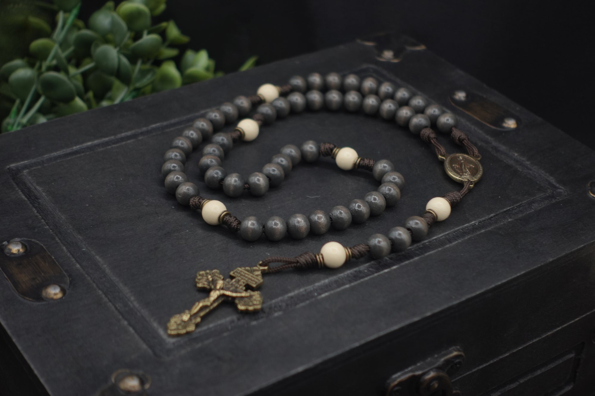 Handcrafted rosary honoring Pope Leo XIV featuring charcoal wood beads, bronze crucifix, and Miraculous Medal centerpiece