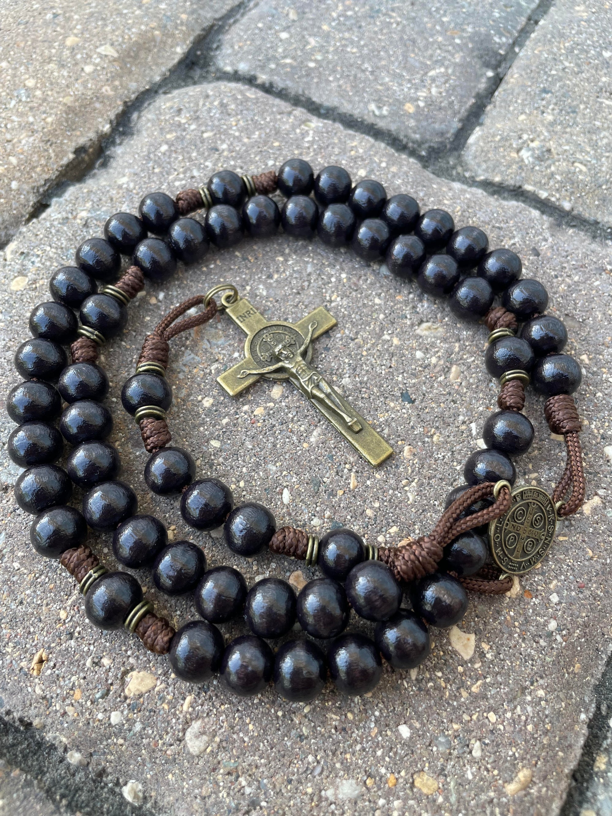 Black Benedictine rosary with black wooden beads, bronze St. Benedict crucifix, and durable walnut paracord