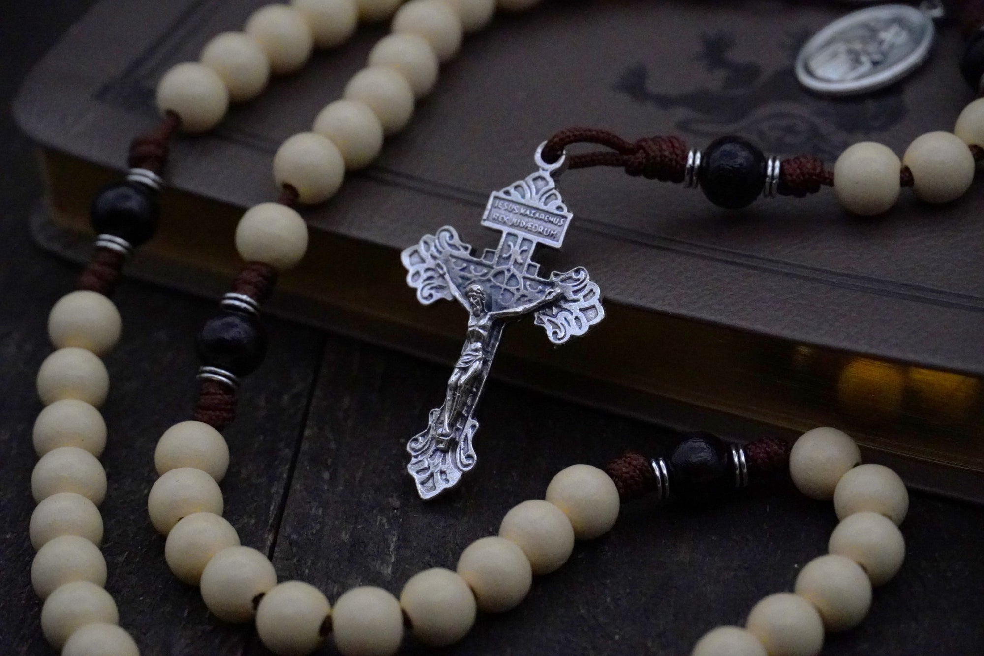 St. Teresa of Ávila rosary with vintage white and black wooden beads, silver Pardon crucifix, and walnut paracord