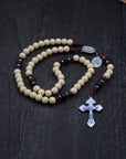 St. Teresa of Ávila rosary by Runewood Rosary combining vintage white and black wood beads, silver crucifix, and walnut paracord for faithful devotion