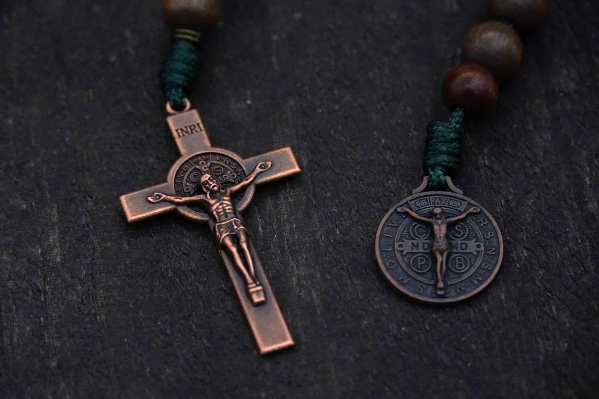 Copper crucifix detail on durable paracord rosary with mixed brown wooden beads
